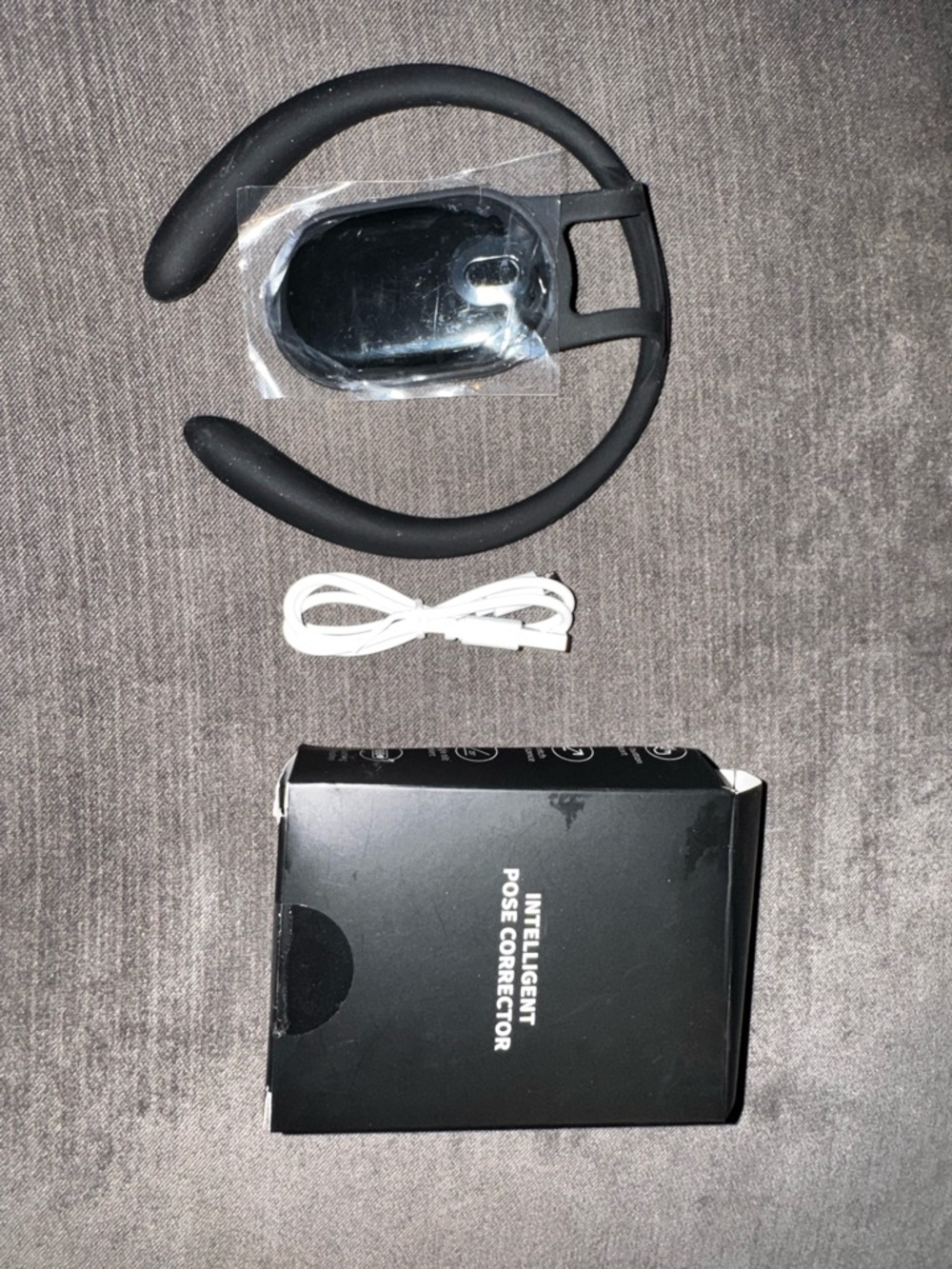 Source Unknown Black Intelligent Pose Corrector with White USB Cable
